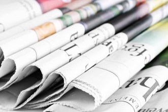 Heap-of-old-newspapers,-selective-focus-000057915480_Medium